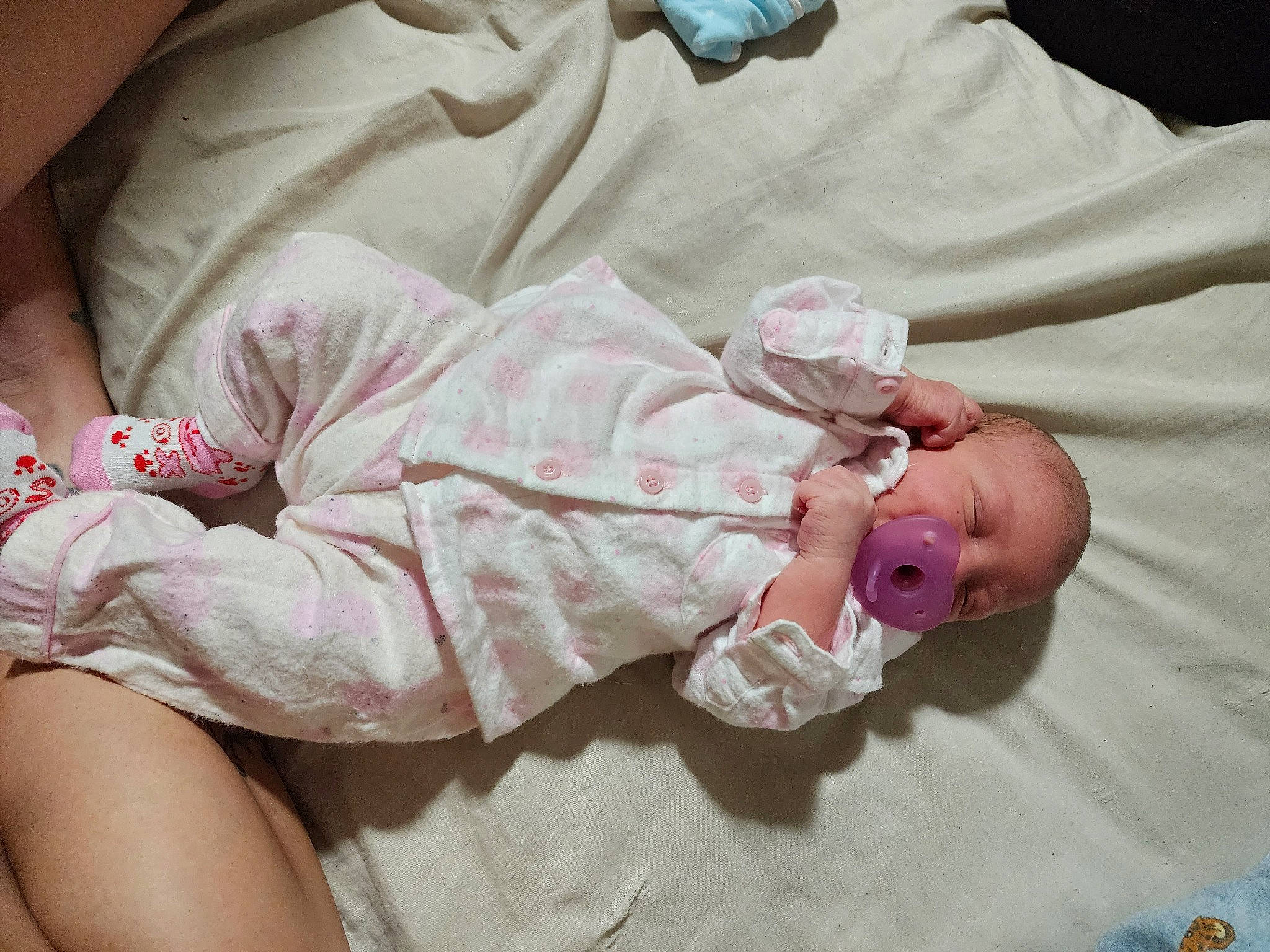 Mika is registered to the contest to win money with this photo: baby, baby_products, baby_sleeping, baby_toddler_clothing, bedding, child, comfort, dress, foot, hand, human_body, human_leg, linens, pattern, person, pink, product, skin, sleeve, thigh