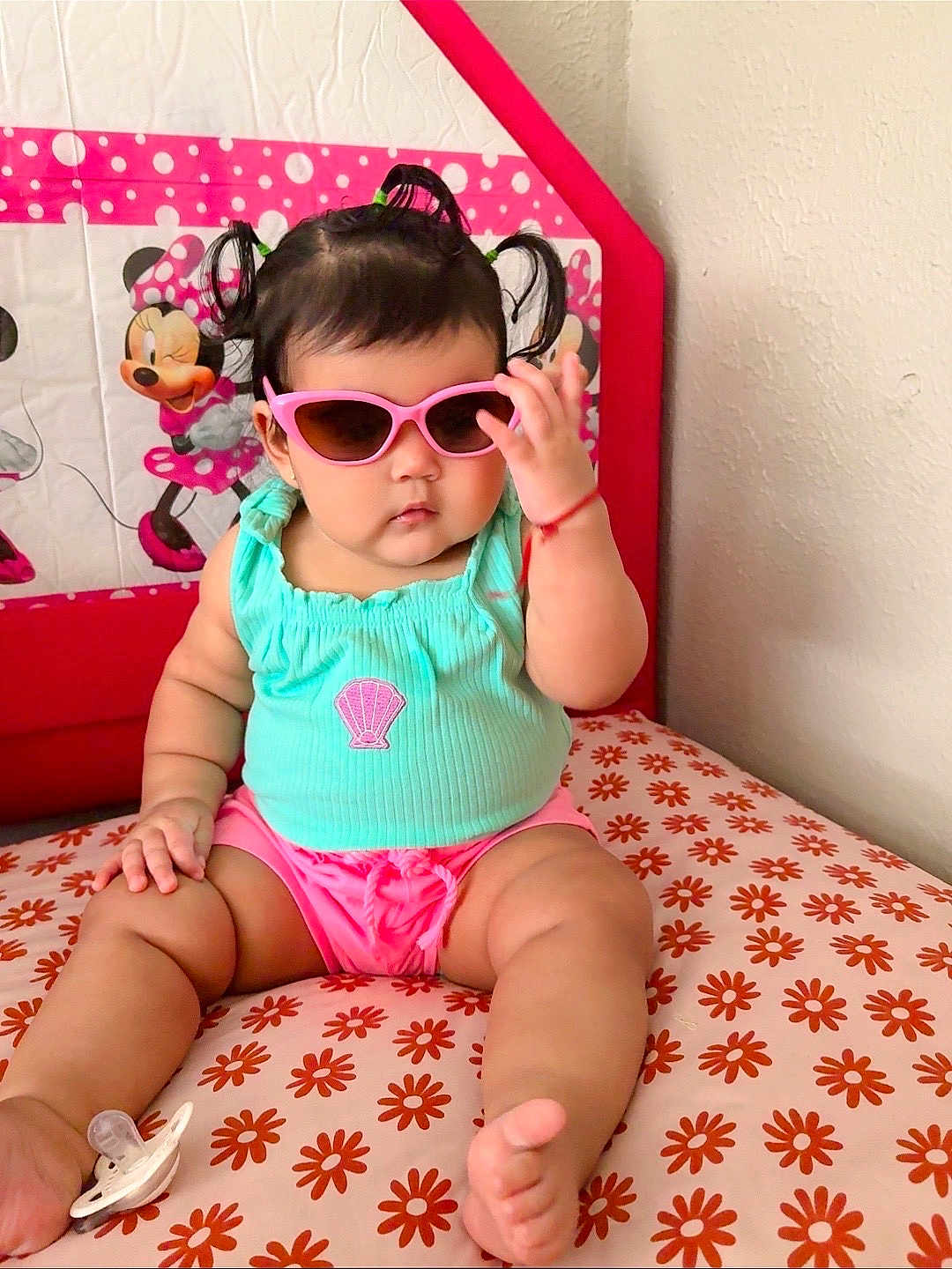 Sharlotte joined the competition — help win amazing prizes! baby, child, sunglasses, pigtails, turquoise_top, pink_shorts, cushion, floral_pattern, minnie_mouse, indoor, cute, portrait, toddler, fashion, accessory, wall, seated, hand, foot, pacifier