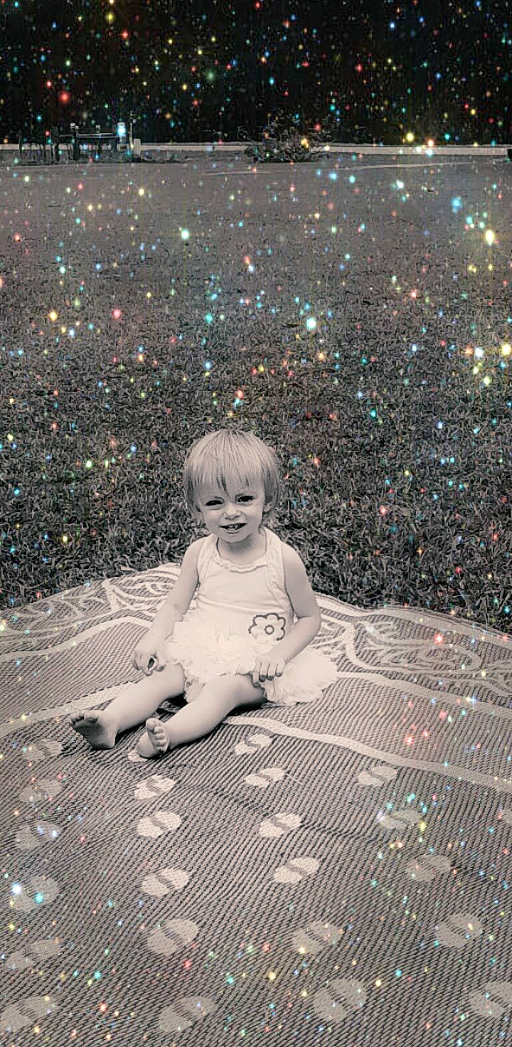 Leanna is registered to the contest to win money with this photo: asphalt, astronomical_object, black, child, flash_photography, floor, flooring, fun, grass, happy, joy, pattern, people_in_nature, person, road_surface, sitting, sky, snapshot, space, tints_and_shades