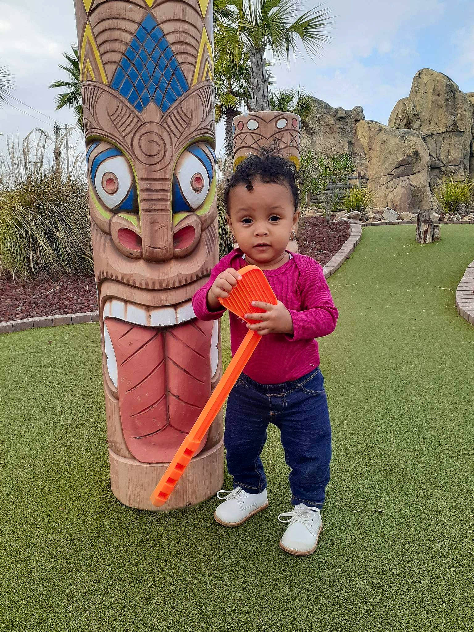 Christina is registered to the contest to win money with this photo: art, artifact, child, fictional_character, fun, grass, hat, human_body, landscape, lawn_ornament, leisure, person, plant, public_space, recreation, sky, toddler, totem, totem_pole, tree