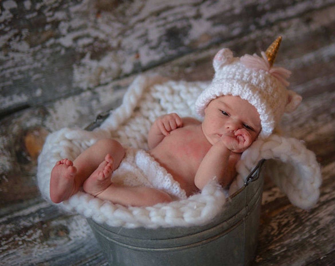 Dakota joined the competition — help win amazing prizes! baby, baby_products, baby_toddler_clothing, child, comfort, embellishment, fashion_accessory, foot, hair_accessory, headgear, headpiece, headwear, pattern, peach, person, pink, plant, portrait_photography, sitting, textile