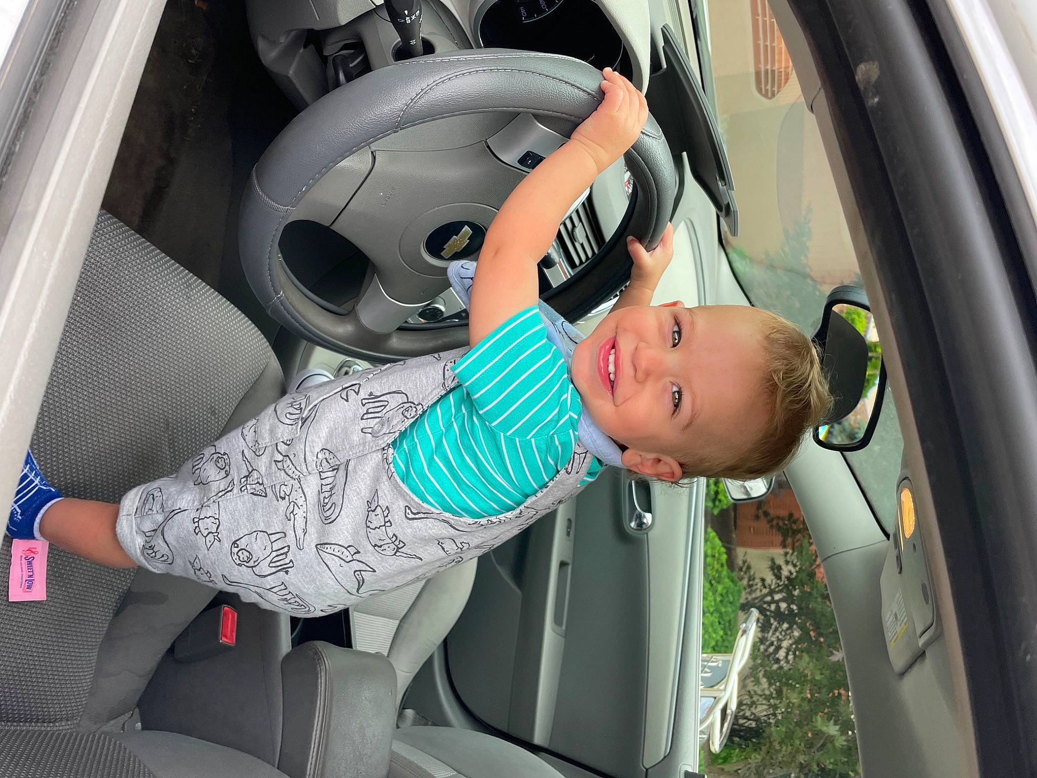 Kaiden is registered to the contest to win money with this photo: auto_part, automotive_design, automotive_exterior, automotive_tire, automotive_wheel_system, automotive_window_part, car, car_seat, car_seat_cover, door, family_car, hood, joy, luxury_vehicle, mode_of_transport, motor_vehicle, person, personal_luxury_car, steering_wheel, toddler