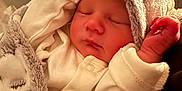Sebastian is registered to the contest to win money with this photo: baby, blanket, child, closeup, clothing, cozy, cute, face, hood, indoor, infant, newborn, peaceful, portrait, resting, skin, sleeping, soft, tiny, warm