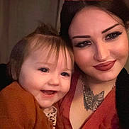 Clary participe au concours pour gagner de l'argent avec cette photo : baby, candid, cheerful, child, closeup, clothing, face, family, hair, happy, indoor, love, makeup, necklace, people, portrait, smile, tattoo, warm_light, woman