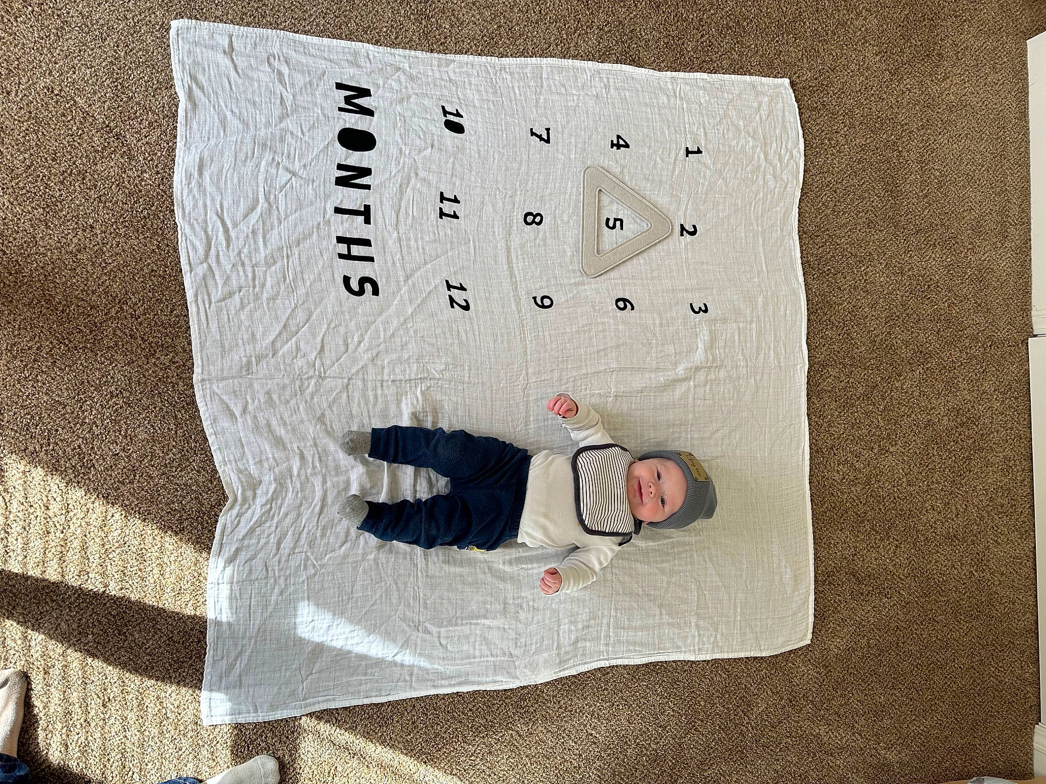 Clayton is registered to the contest to win money with this photo: art, bedding, child, circle, comfort, font, headwear, home_accessories, illustration, linens, paper, paper_product, pattern, person, rectangle, room, sleeve, textile, throw_pillow, visual_arts