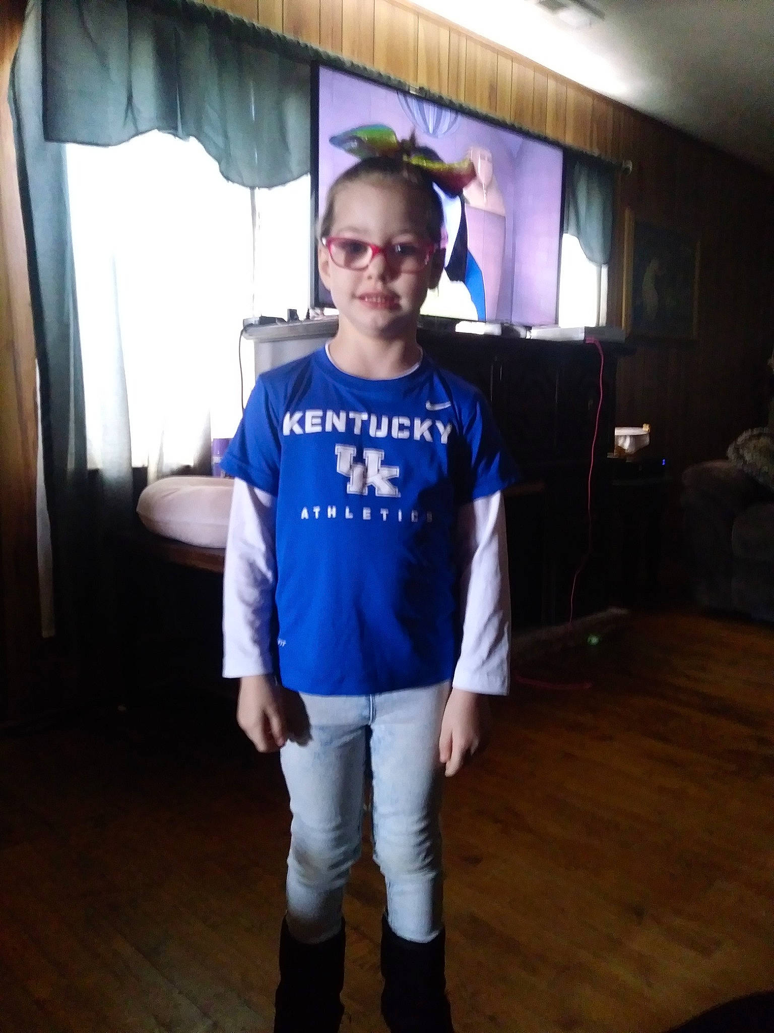 Kayleeann is registered to the contest to win money with this photo: child, cool, footwear, fun, glasses, person, shoe, shoulder, sleeve, smile, standing, t_shirt