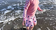 Jeston joined the competition — help win amazing prizes! child, toddler, beach, ocean, seaside, water, waves, surf, foam, splashing, outdoors, summer, pink_shirt, shorts, fish_pattern, barefoot, walking, profile, sunlight, portrait