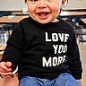 Edith joined the competition — help win amazing prizes! adult_hand, baby, black_sweater, blue_pants, chair, child, classroom, close_up, clothing, eyes, face, furniture, happy, indoor, love_text, portrait, smiling, table, teeth, toddler