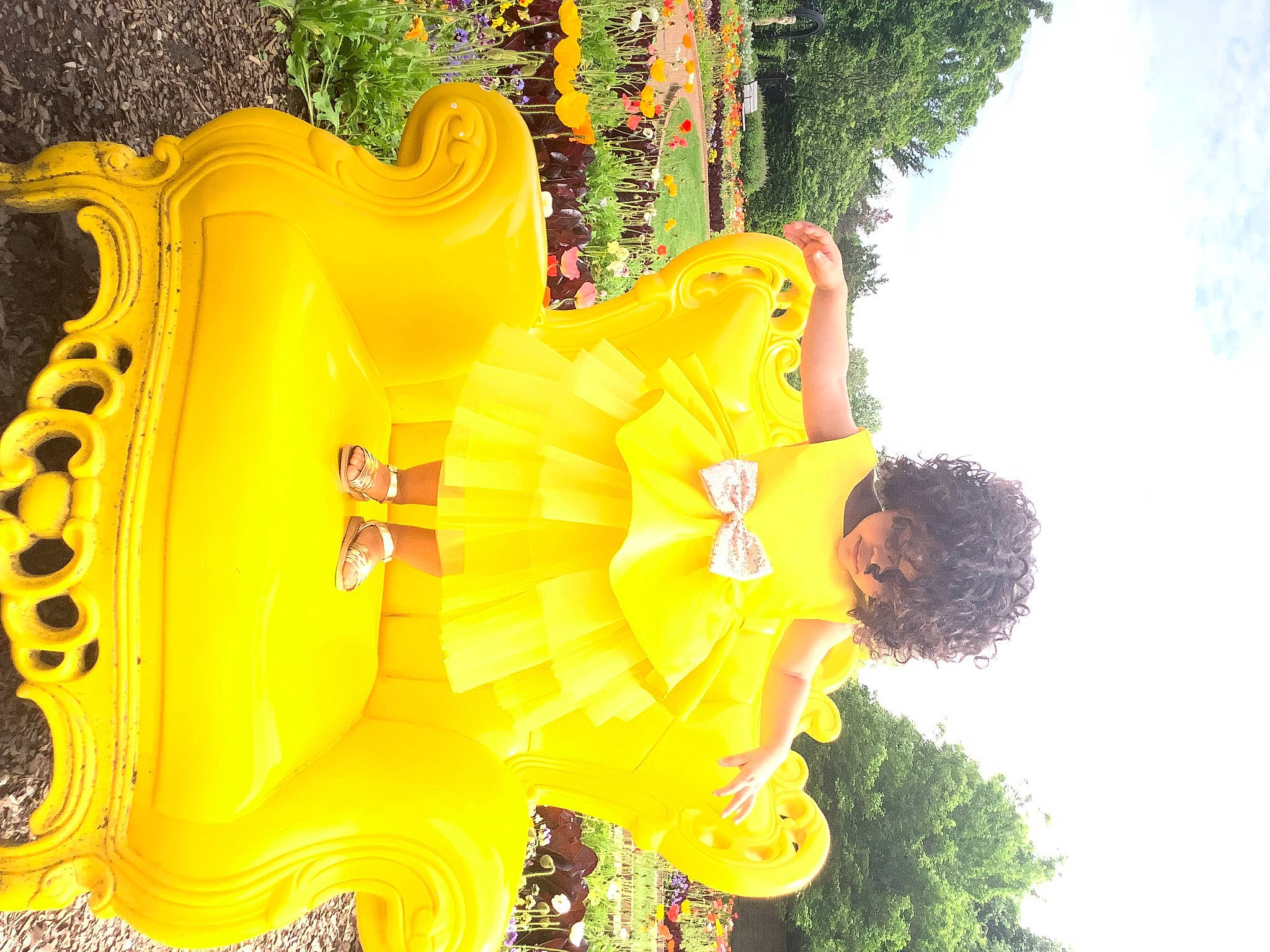 Nayla is registered to the contest to win money with this photo: auto_part, automotive_wheel_system, child, event, font, fun, grass, green, happy, leisure, light, musical_instrument, plant, recreation, sky, toddler, tourism, tree, wheel, yellow