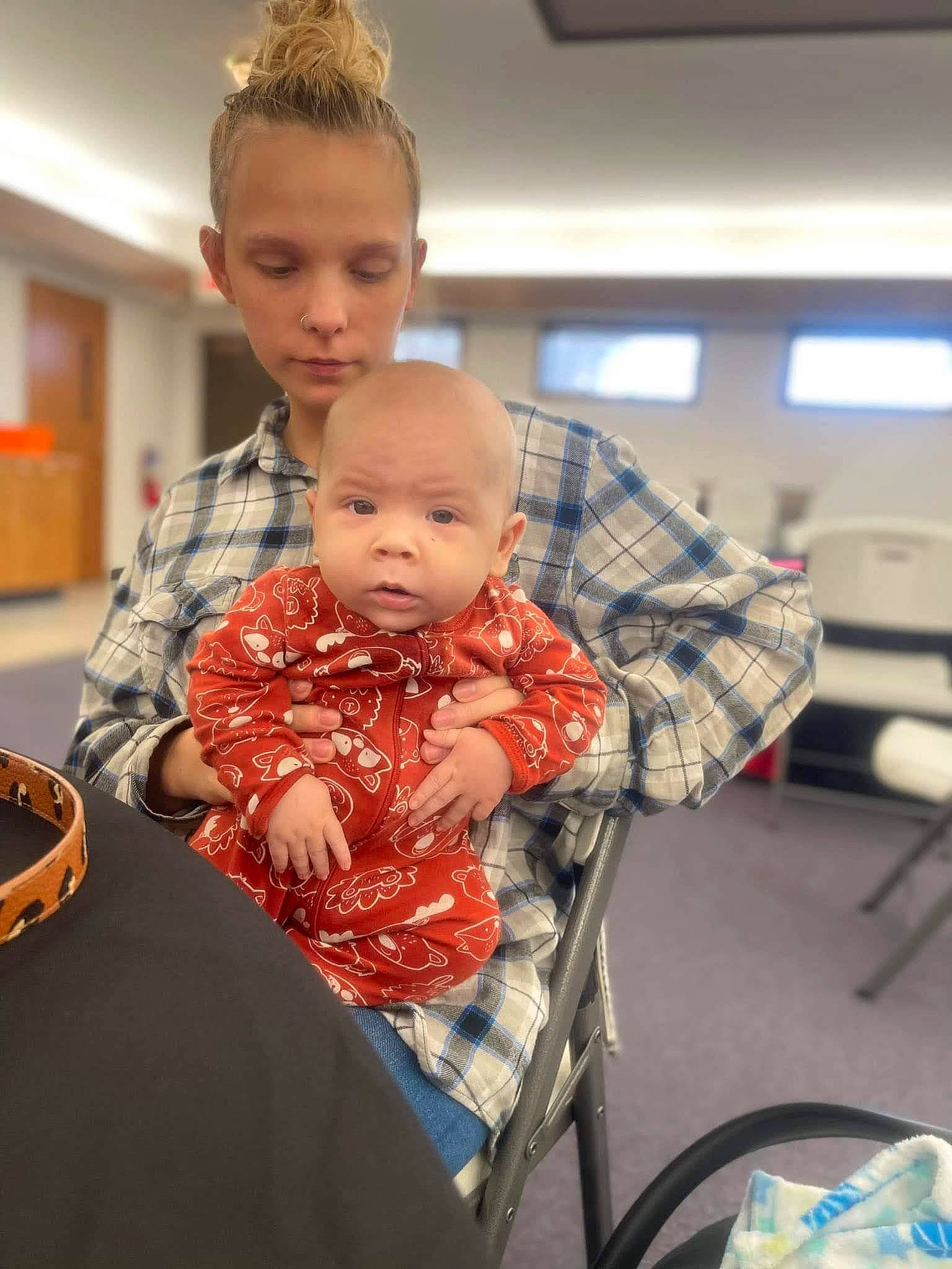 Emery is registered to the contest to win money with this photo: baby, chair, child, comfort, event, face, family, fashion_design, fun, hairstyle, happy, head, person, plaid, room, sitting, toddler, vacation