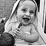 Ella-Rose is registered to the contest to win money with this photo: baby, child, towel, toy, smiling, happy, face, hands, hood, black_and_white, portrait, infant, laughter, outdoor, highchair, skin, person, cute, expression, closeup