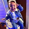 toddler, child, smiling, high_chair, denim_jacket, headband, indoor, clothing, sunflower, jeans, socks, shoes, person, cute, happy, portrait, baby, fashion, playful, furniture