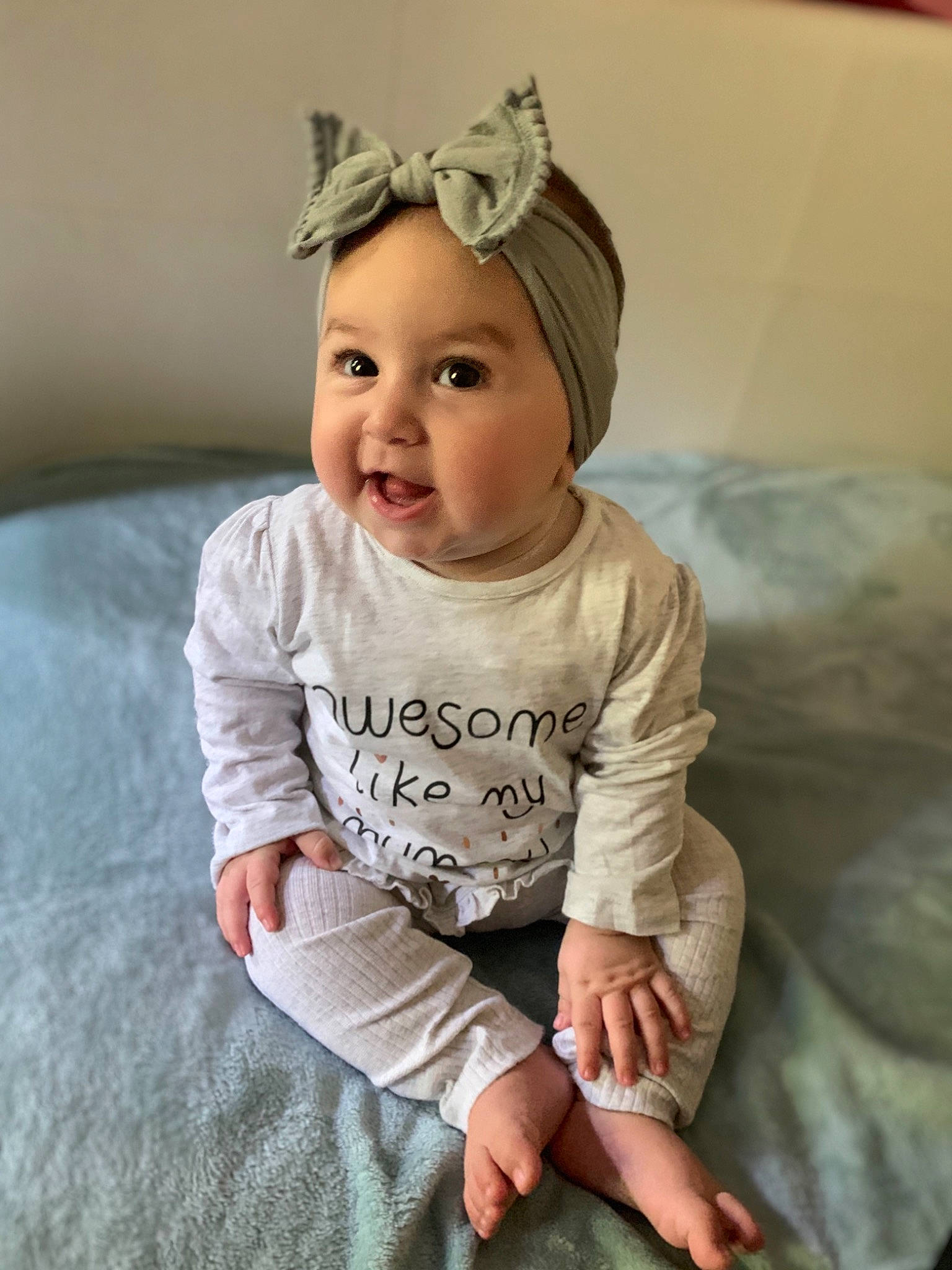 Lani joined the competition — help win amazing prizes! arm, baby, baby_toddler_clothing, cheek, child, child_model, ear, facial_expression, hair_accessory, happy, head, headband, headgear, headwear, person, photography, product, sitting, sleeve, smile
