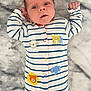 baby, infant, onesie, striped_clothing, animal_patches, lying_down, blanket, soft_texture, cute, young_child, face, hands, fingers, blue_eyes, expression, indoor, cozy, sleepwear, child, newborn