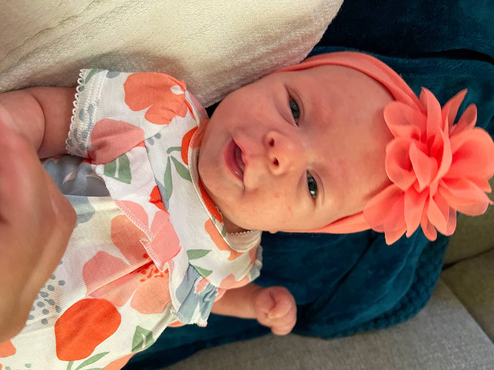 Oakleigh is registered to the contest to win money with this photo: arm, baby, baby_toddler_clothing, cheek, comfort, eye, finger, hand, headwear, human_body, lip, mouth, nail, nose, orange, person, pink, product, red, skin