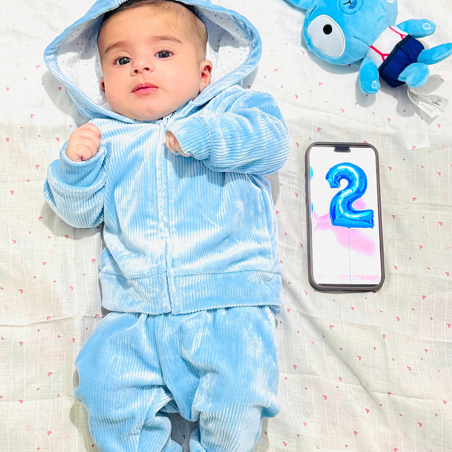 Saleha joined the competition — help win amazing prizes! baby, balloon, blanket, blue_bunny, blue_clothing, celebration, cute, face, feet, hand, hoodie, indoors, infant, lying_down, number_2, phone, portrait, soft_texture, stuffed_animal, velour