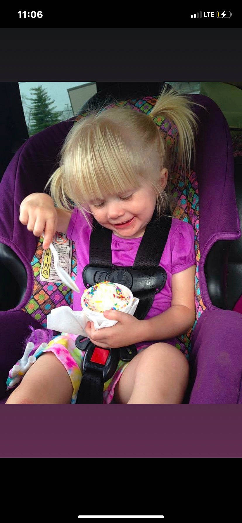 Kenzie Jo is registered to the contest to win money with this photo: baby_toddler_clothing, blond, child, event, eyewear, fun, grass, hairstyle, happy, human_leg, joy, lap, magenta, person, pink, purple, sitting, skin, smile, thigh