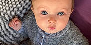 Charly a rejoint le concours — aidez-le/la à gagner de superbes lots ! baby, blue_eyes, sweater, toy, blanket, indoor, child, curious, cute, fuzzy_clothing, person, infant, playing, closeup, portrait, small_hand, seated, soft_texture, warm, looking_up