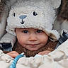 baby, child, hat, winter_clothing, cute, smile, face, fur, warm, cozy, hands, infant, portrait, closeup, outdoor, bundle, expression, apparel, headwear, baby_carrier