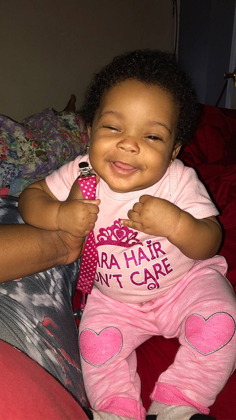 Isabella joined the competition — help win amazing prizes! arm, baby, black_hair, cheek, child, eye, face, fun, joy, leg, lip, person, pink, sitting, skin, smile, thigh, toddler