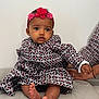 Safiya a rejoint le concours — aidez-le/la à gagner de superbes lots ! baby, child, infant, dress, headband, flower, pattern, foot, toes, hand, cushion, sitting, indoor, person, cute, skin, portrait, clothing, support, curious
