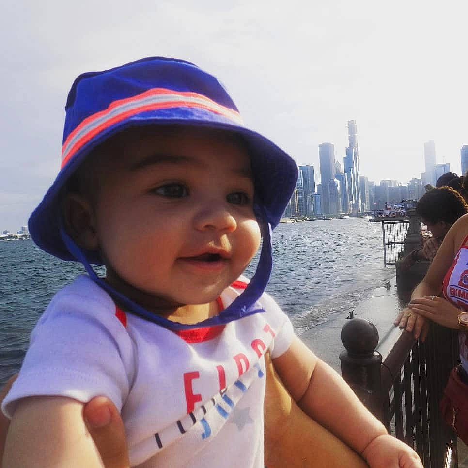 Franklin is registered to the contest to win money with this photo: baby, child, cool, fashion_accessory, happy, hat, headgear, lifejacket, person, personal_protective_equipment, summer, sun_hat, toddler, tourism, vacation, vehicle