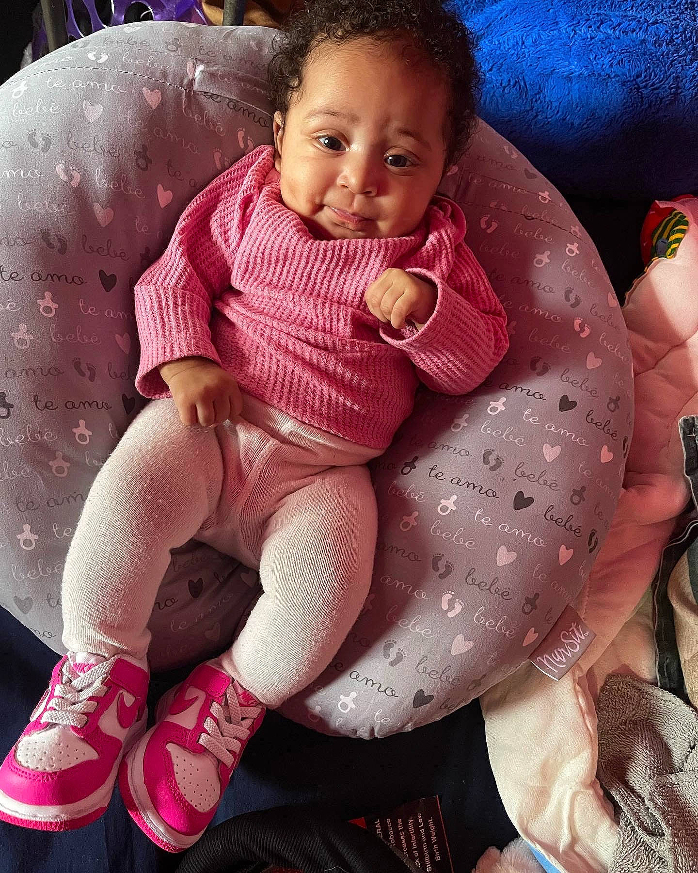 Aunesti is registered to the contest to win money with this photo: baby, baby_toddler_clothing, cheek, comfort, eye, facial_expression, finger, hairstyle, hand, head, human_body, knee, lap, leg, lip, mouth, person, pink, skin, smile