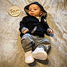 baby, infant, hoodie, sneakers, blanket, wooden_sign, three_months, clothing, casual_wear, footwear, person, portrait, laying_down, soft_texture, milestone, cute, child, young, indoors, resting
