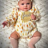 baby, infant, child, portrait, lying_down, blanket, fluffy_blanket, onesie, pumpkin_pattern, hat, socks, milestone_sign, four_months, blue_eyes, looking_at_camera, indoors, soft_lighting, nursery, baby_photography, cute