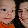 Brendon is registered to the contest to win money with this photo: baby, child, person, face, portrait, closeup, orange_clothing, woman, relaxed, indoor, pillow, head, skin, smile, casual, young, family, cozy, resting, together