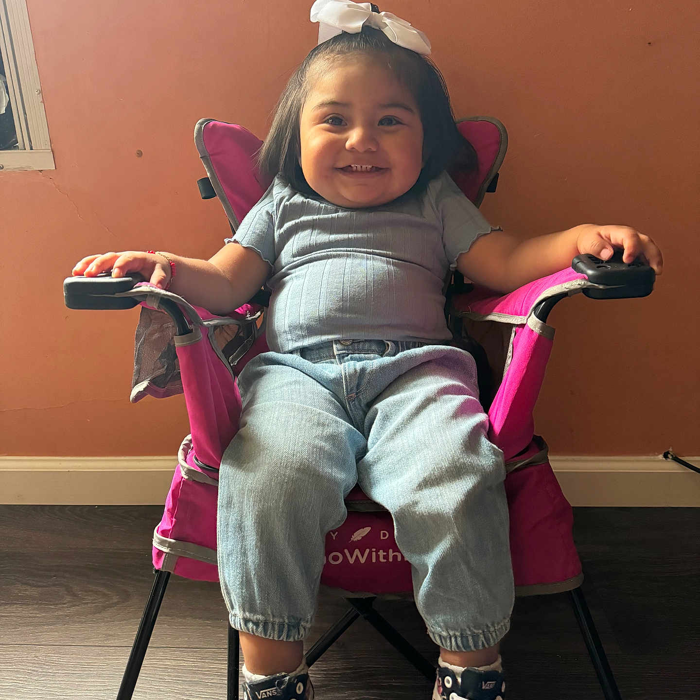 Mia is registered to the contest to win money with this photo: chair, child, clothing, e_scooter, face, female, footwear, furniture, girl, happy, head, pants, person, photography, portrait, shoe, sitting, smile, transportation, vehicle