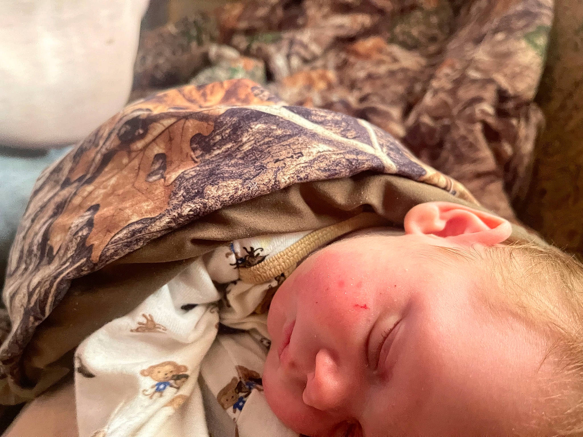 Easton joined the competition — help win amazing prizes! baby, baby_products, baby_toddler_clothing, cheek, child, comfort, eye, face, gesture, grass, happy, headgear, military_camouflage, pattern, people_in_nature, person, skin, sleep, toddler, wood