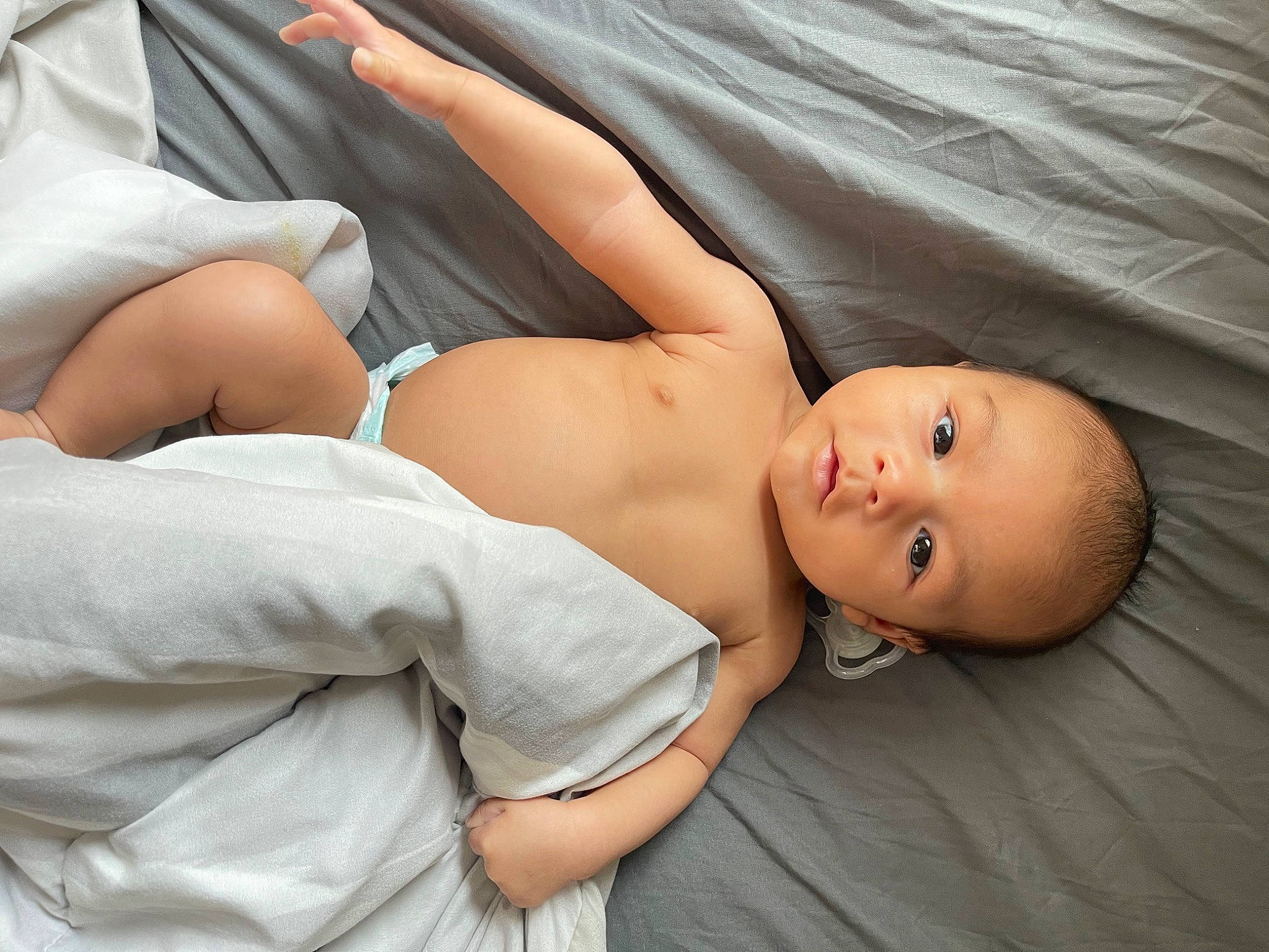 Jahviel is registered to the contest to win money with this photo: abdomen, baby, barefoot, chest, comfort, elbow, flash_photography, foot, human_body, human_leg, joint, knee, leg, linens, muscle, navel, person, stomach, thigh, toddler