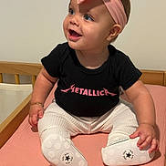 Ayva joined the competition — help win amazing prizes! baby, infant, child, smile, headband, pink, black_shirt, metallica, blue_eyes, sitting, bed, pink_sheet, white_pants, baby_shoes, bracelet, cute, happy, indoors, portrait, person