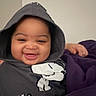 Unique joined the competition — help win amazing prizes! baby, child, smiling, portrait, hoodie, blanket, purple_blanket, indoor, face, happy, sitting, close_up, clothing, infant, dark_clothing, purple, home, soft_lighting, person, photography