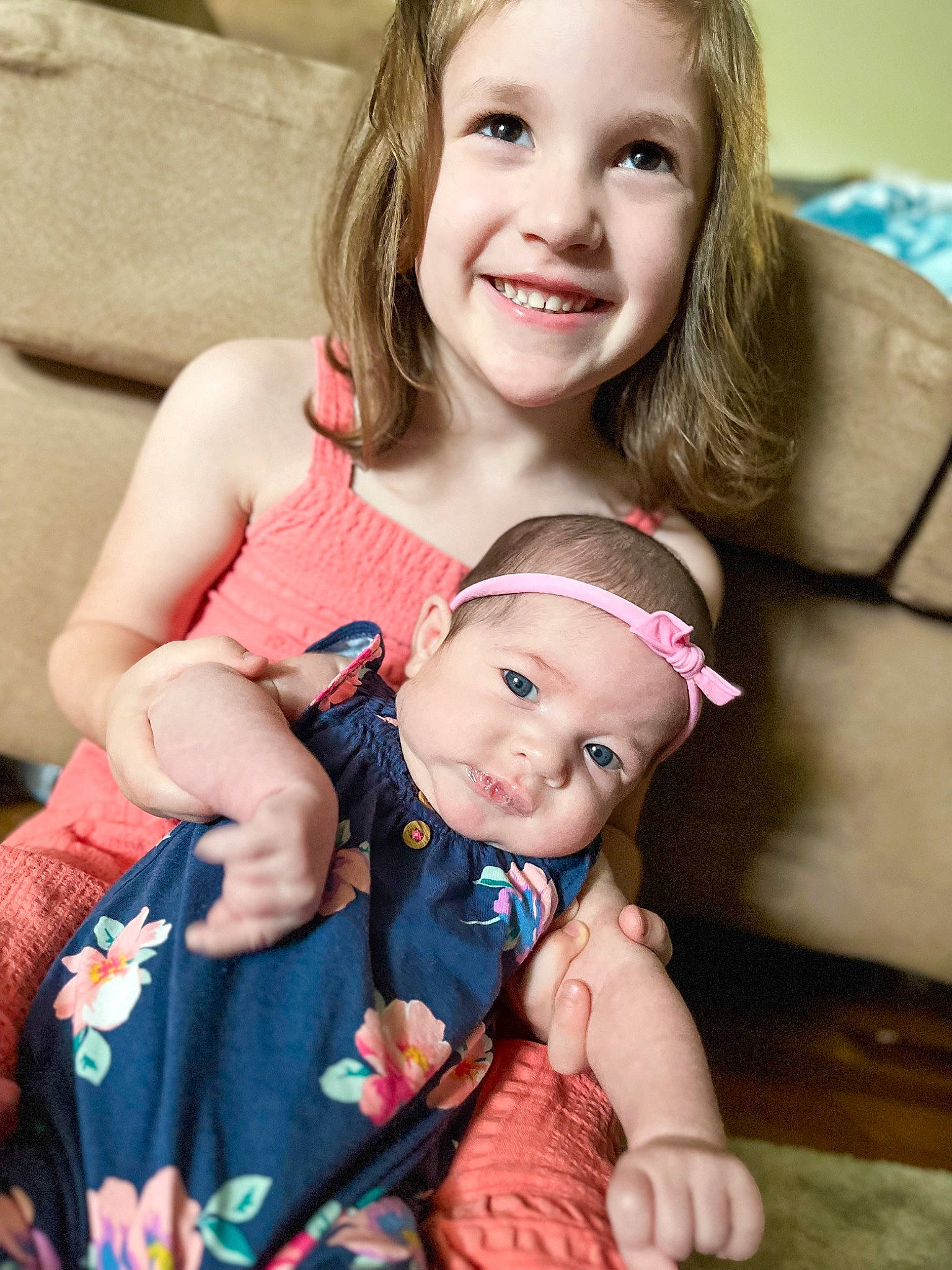 Addie is registered to the contest to win money with this photo: arm, baby, baby_toddler_clothing, cheek, child, dress, eye, face, facial_expression, finger, fun, gesture, hand, happy, human_body, iris, joy, person, photograph, skin