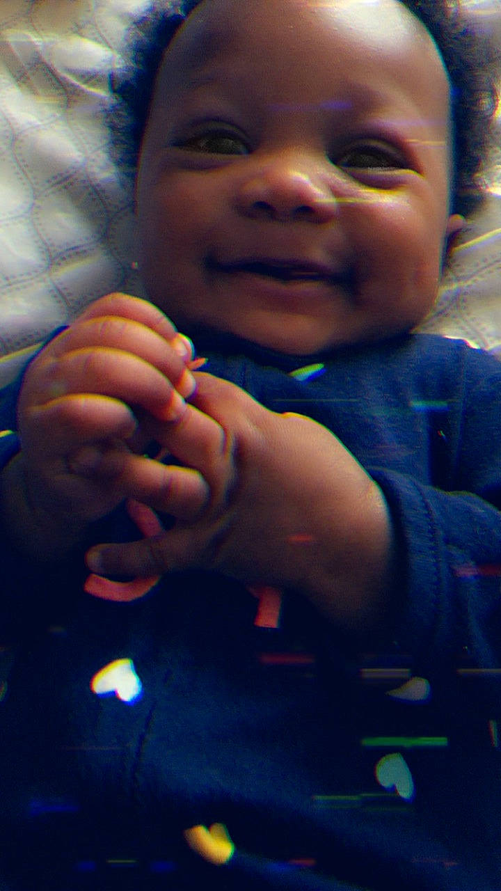 Rylee is registered to the contest to win money with this photo: baby, blue, cheek, child, cool, face, facial_expression, finger, forehead, hand, head, lip, mouth, nail, nose, orange, person, skin, smile, thumb