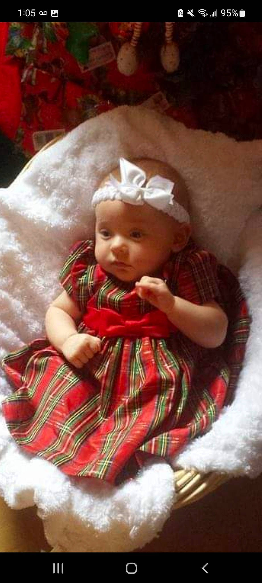 Isabella is registered to the contest to win money with this photo: baby, baby_toddler_clothing, cheek, child, comfort, design, dress, facial_expression, hand, headwear, linens, pattern, person, plaid, sitting, skin, sleeve, smile, sock, tartan