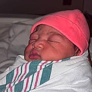London is registered to the contest to win money with this photo: newborn, baby, sleeping, wrapped, blanket, pink_hat, infant, face, cute, hospital, swaddled, peaceful, child, portrait, cozy, soft, tiny, human, newborn_baby, closeup