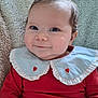 baby, infant, smile, red_clothing, blue_collar, heart_pattern, knitted_blanket, cozy, cute, portrait, child, indoors, happy, face, person, head, sitting, young_child, toddler, warm
