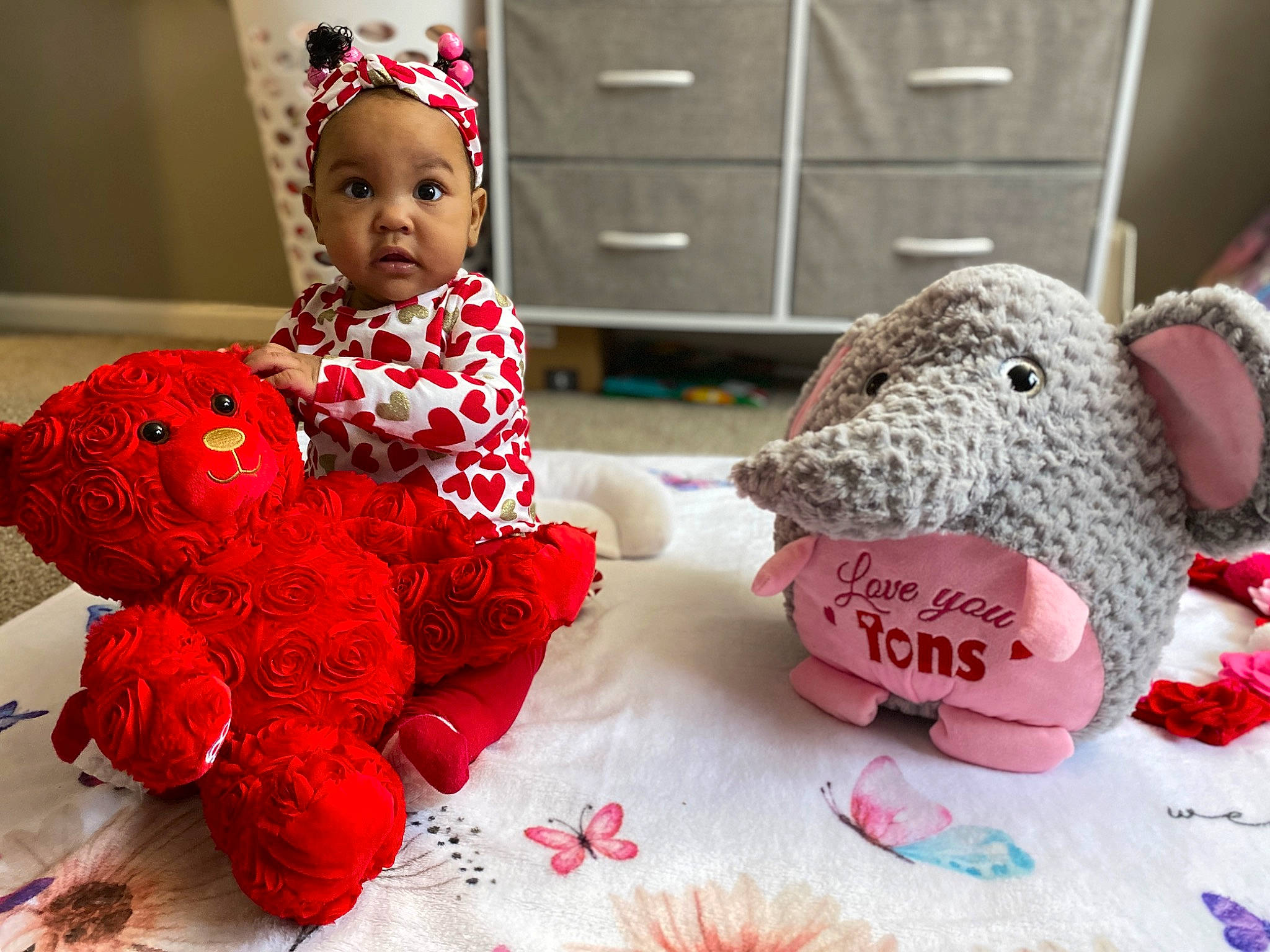 Persephone is registered to the contest to win money with this photo: art, baby_toddler_clothing, cabinetry, drawer, event, fashion_accessory, happy, headgear, linens, pattern, person, petal, pink, plush, product, room, stuffed_toy, textile, toy, white