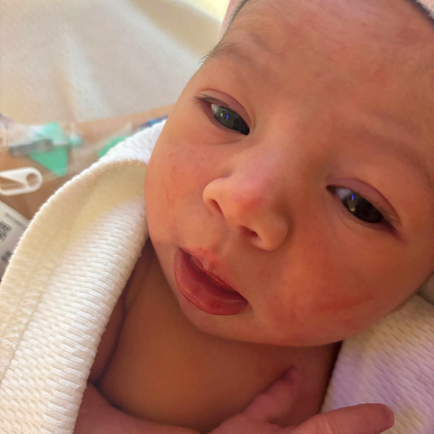 Isella is registered to the contest to win money with this photo: baby, blanket, child, closeup, cute, expression, face, hand, hat, human, infant, newborn, newborn_baby, portrait, skin, sleepy, small, soft, warm, wrapped