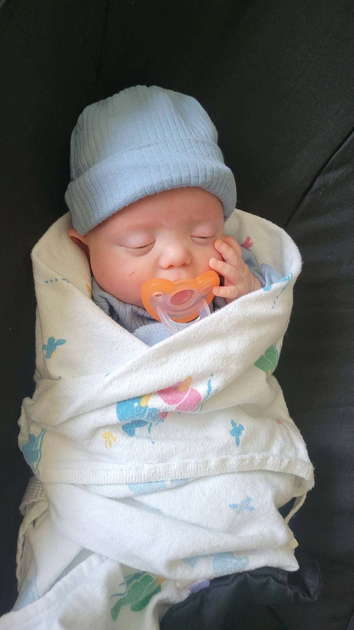 Dax is registered to the contest to win money with this photo: baby, baby_products, baby_sleeping, baby_toddler_clothing, cap, cheek, child, chin, comfort, eye, hand, head, headwear, human_body, knit_cap, lip, mouth, nose, person, skin