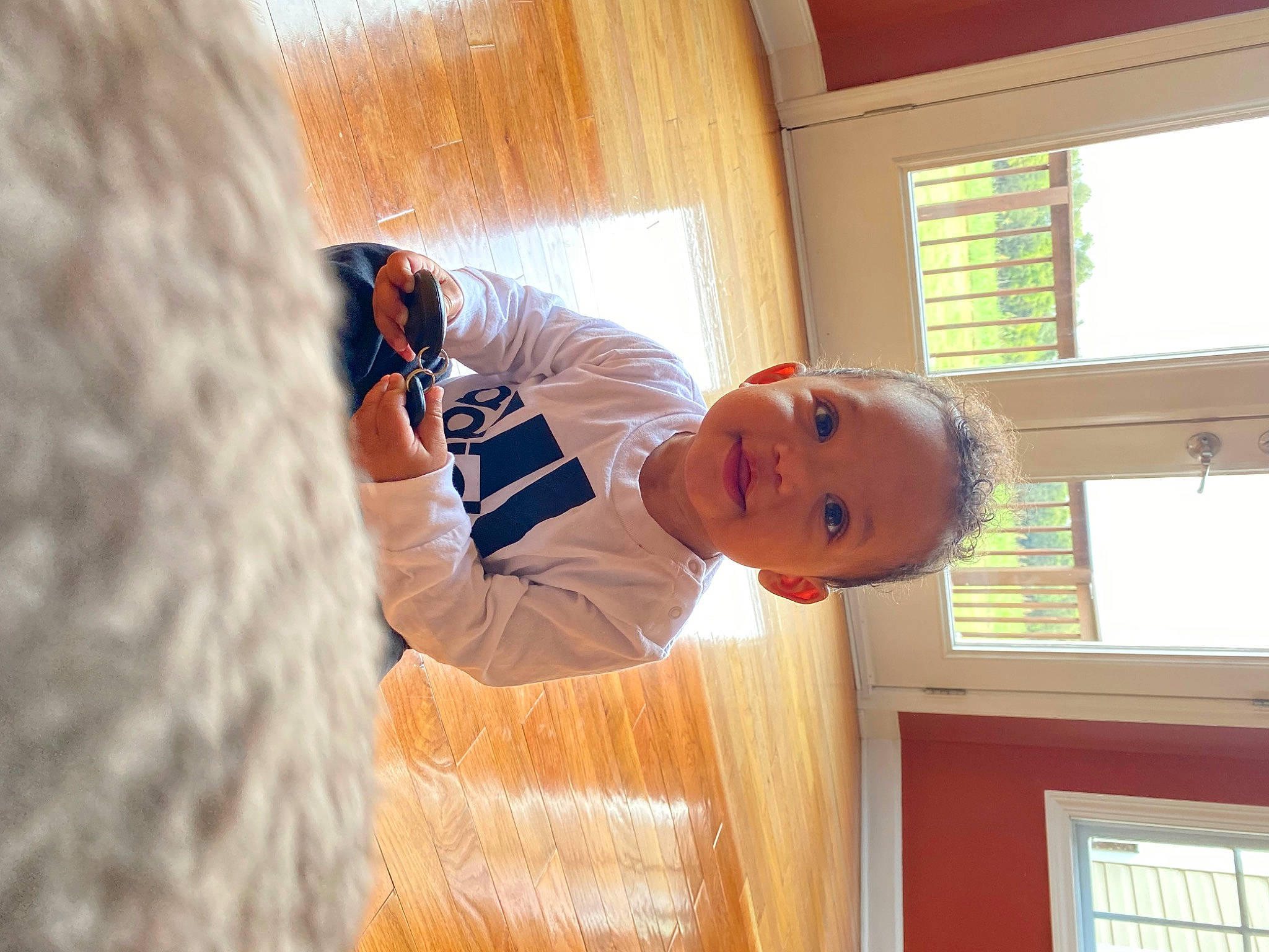 Aziel is registered to the contest to win money with this photo: baby, baseball_cap, ceiling, child, door, elbow, flooring, fun, happy, hardwood, hat, house, leisure, person, room, smile, t_shirt, toddler, window, wood