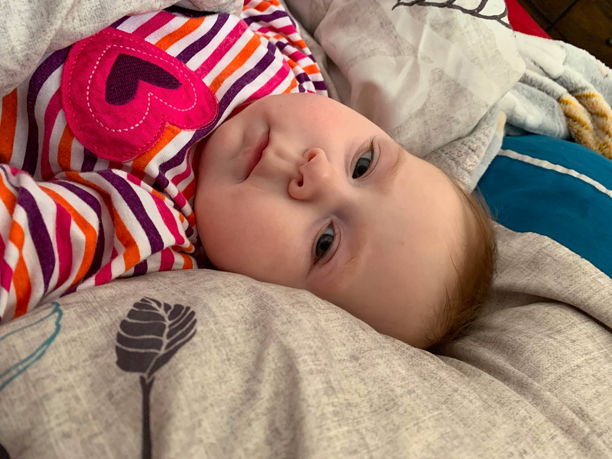 Freyja is registered to the contest to win money with this photo: audio_equipment, baby, baby_toddler_clothing, carmine, cheek, child, comfort, eyelash, headgear, linens, lip, mammal, nose, pattern, person, portrait_photography, room, skin, sleeve, textile