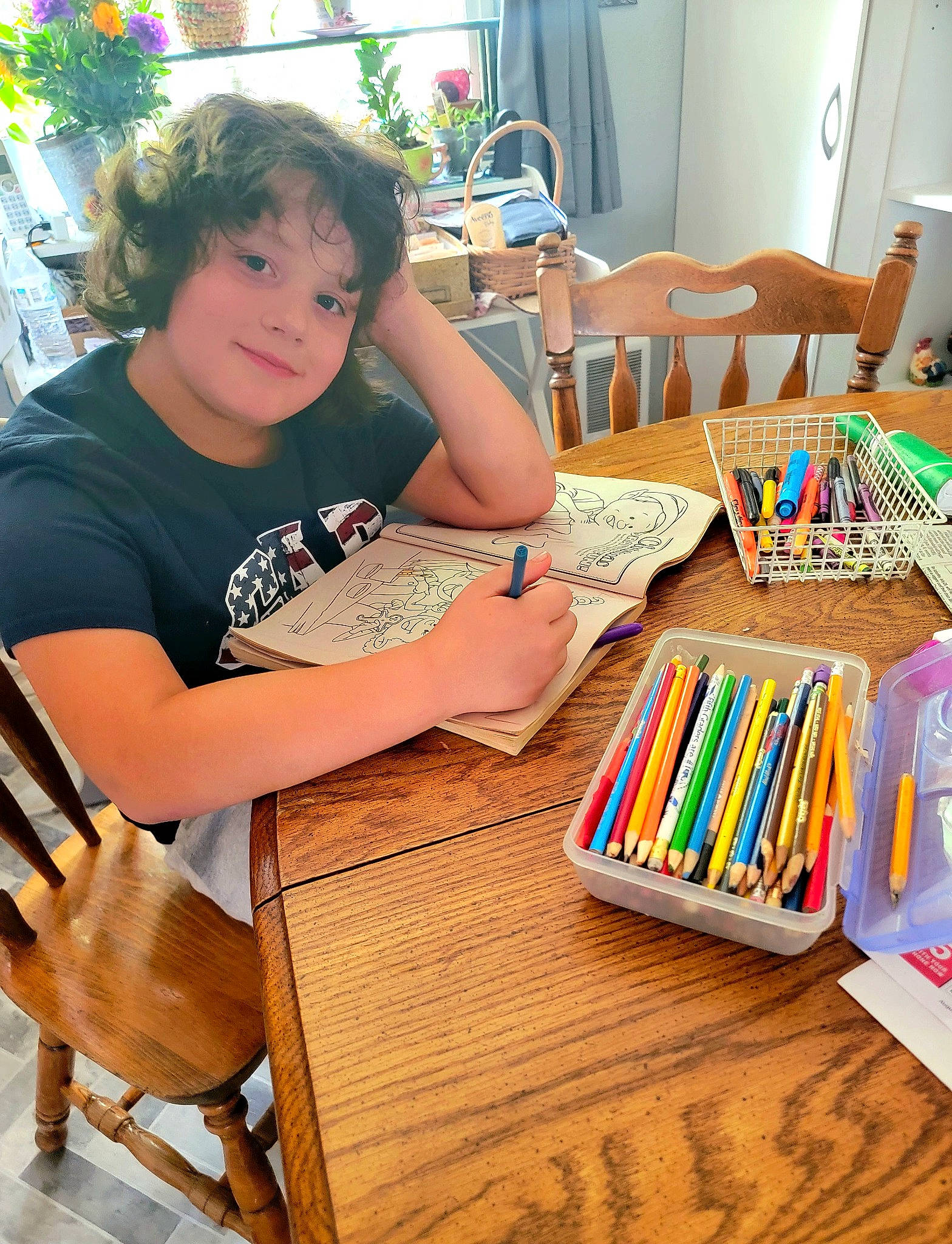 Carter is registered to the contest to win money with this photo: art, artist, chair, child, desk, fun, furniture, hardwood, joy, leisure, office_supplies, person, plant, recreation, room, sharing, summer, t_shirt, table, wood