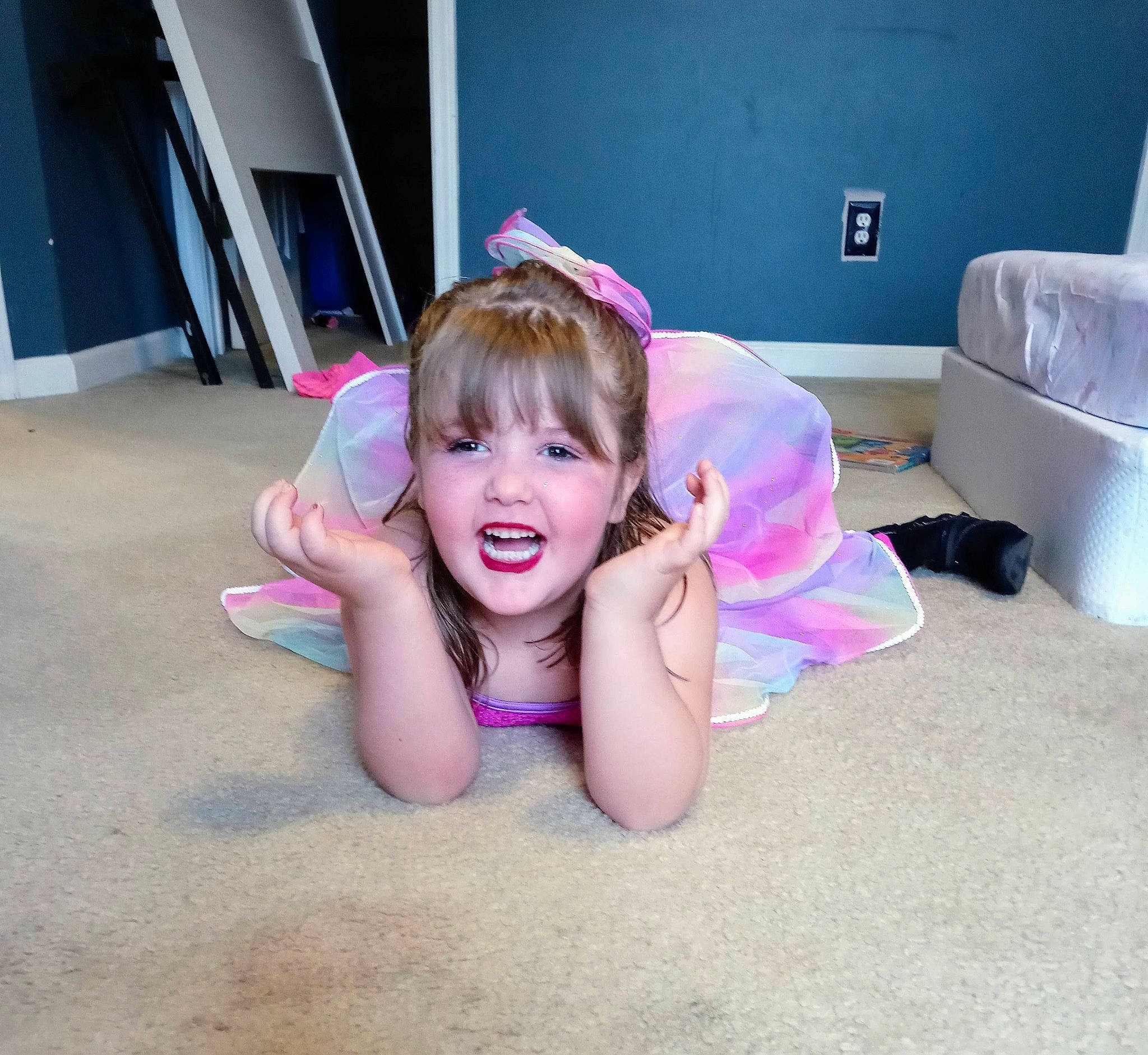 Alyssa Quigley joined the competition — help win amazing prizes! baby_toddler_clothing, child, ear, fashion_accessory, floor, flooring, fun, gesture, happy, leisure, magenta, person, pink, purple, room, sitting, smile, sportswear, thumb, toddler