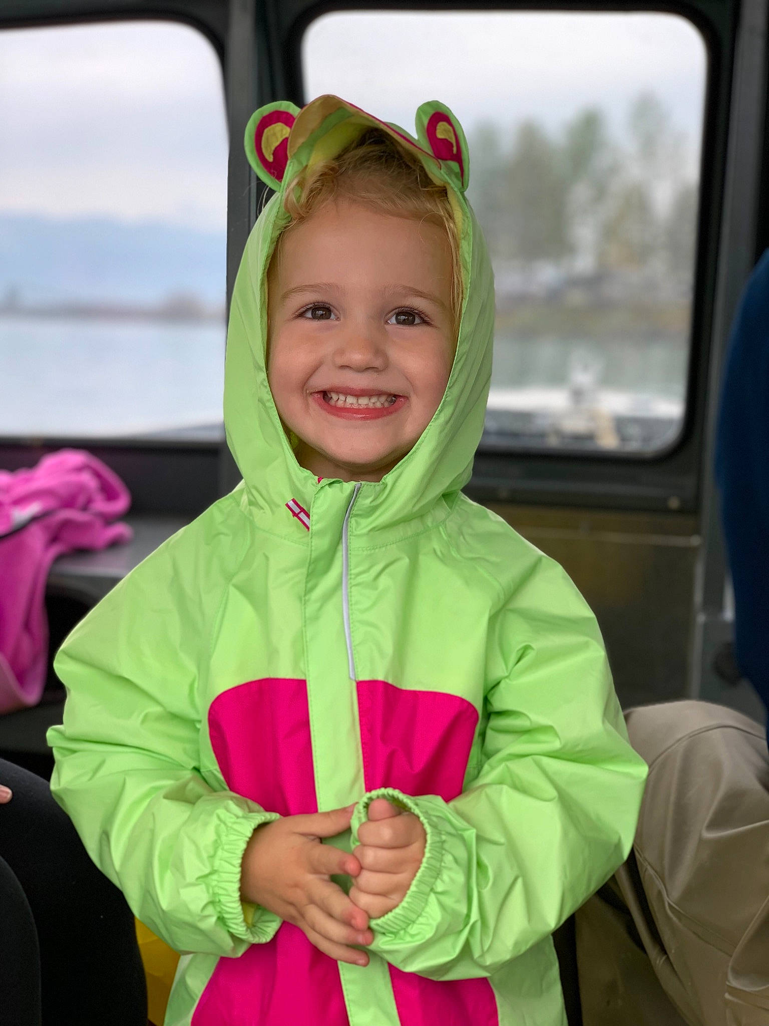 Sanza joined the competition — help win amazing prizes! car, car_seat, child, costume, face, fun, green, jacket, joy, outerwear, person, personal_protective_equipment, pink, plant, smile, toddler, vacation, vehicle