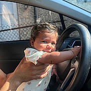 Melody joined the competition — help win amazing prizes! baby, car, casual, child, clothing, cute, expression, face, hand, holding, infant, interior, person, portrait, seat, skin, steering_wheel, sunlight, window, young