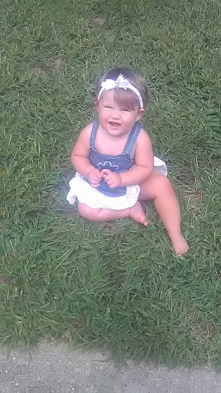 Kennedy is registered to the contest to win money with this photo: child, fun, grass, grass_family, lawn, person, plant, play, sitting, smile, toddler